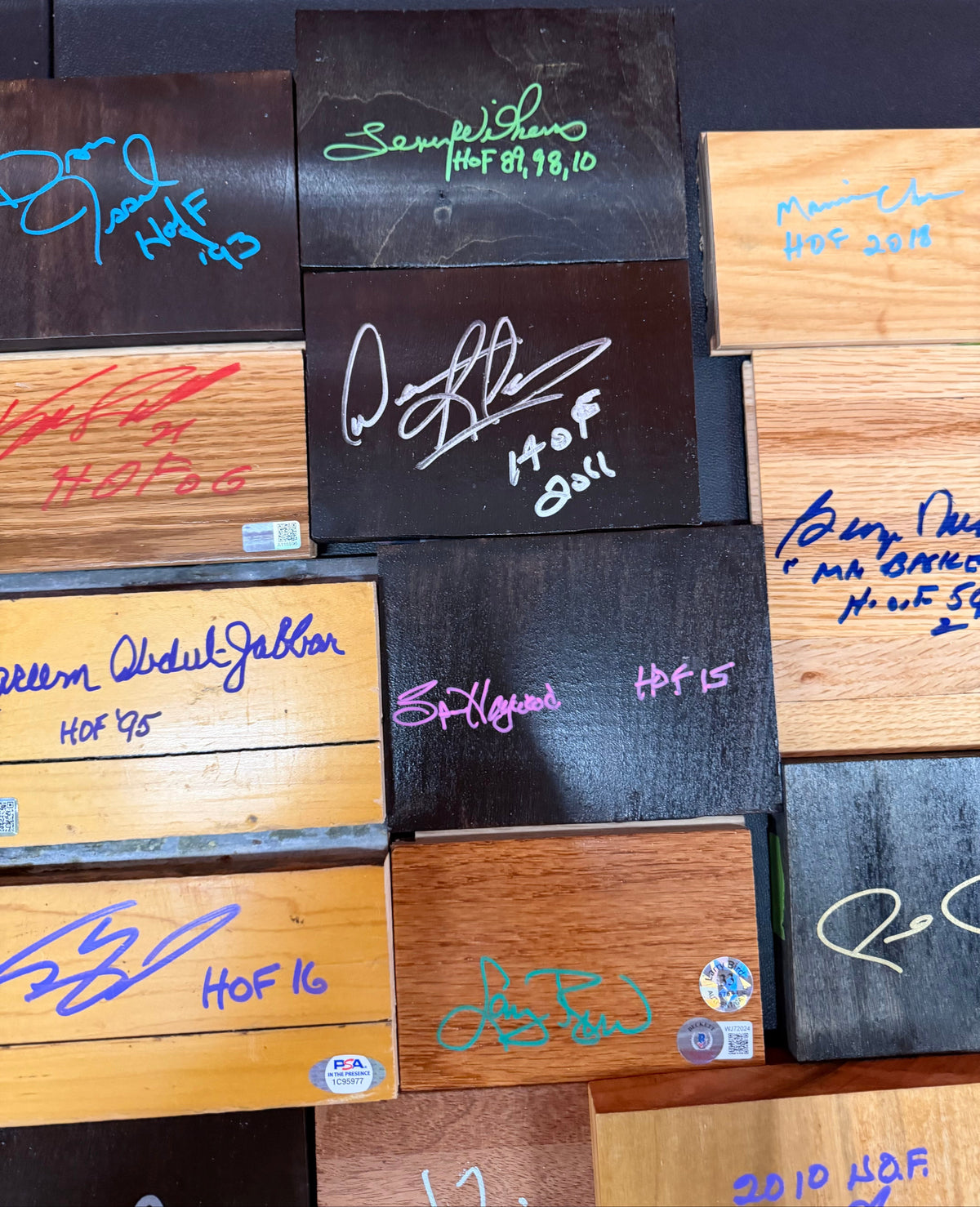 Game Used Floor and Wood Pieces Signed by NBA Hall of Famers - Collection Lot